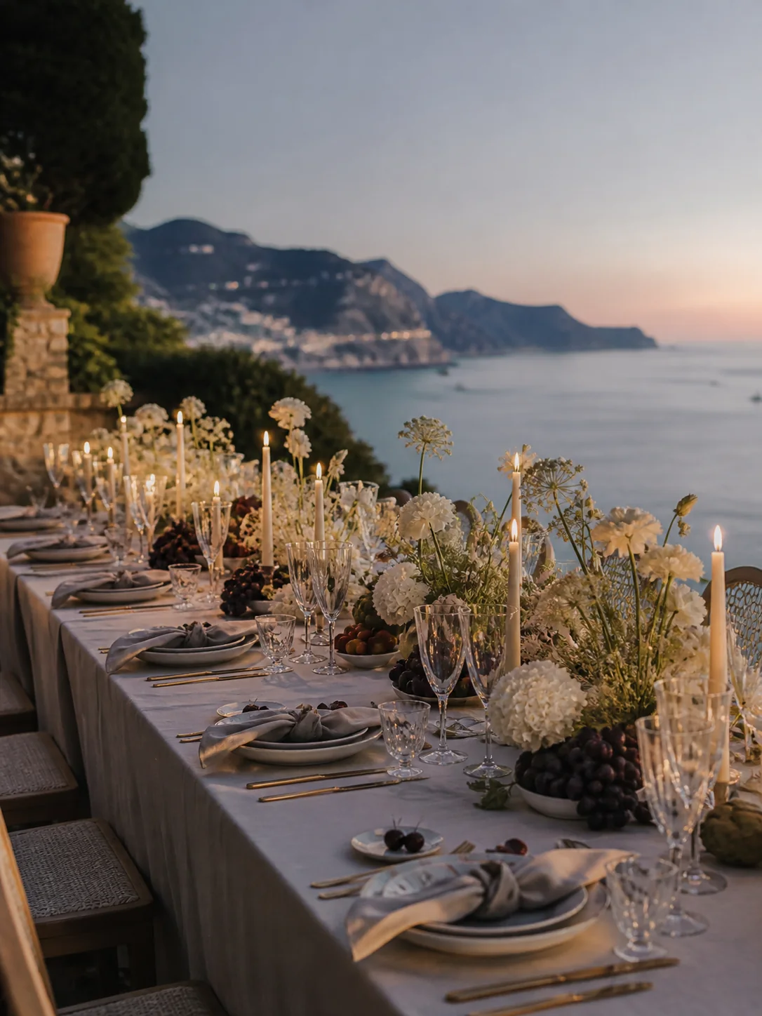 A Mediterranean destination wedding tablescape set at dusk